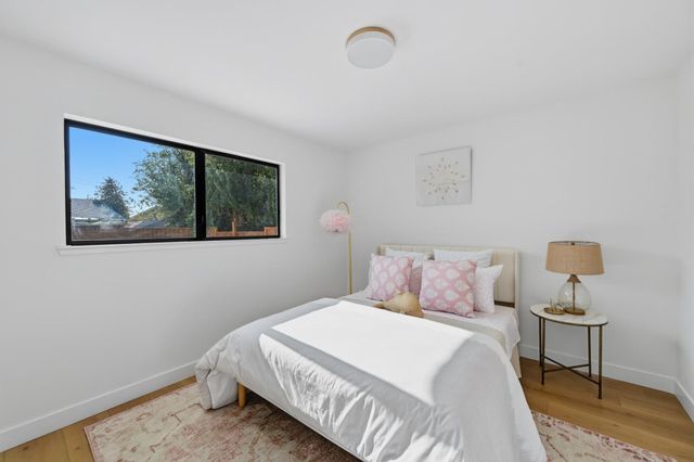 a bedroom with a bed and a painting on the wall