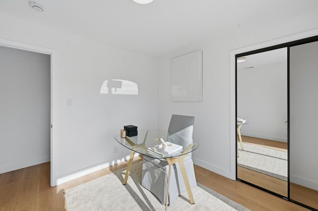 a bedroom with furniture and wooden floor