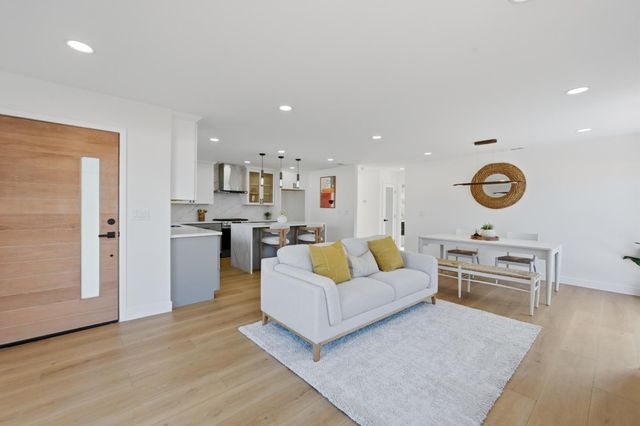 a living room with furniture and a kitchen