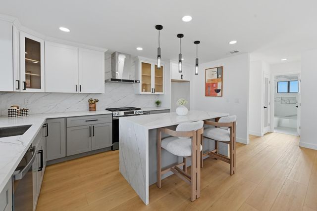 a kitchen with a sink cabinets and wooden floor