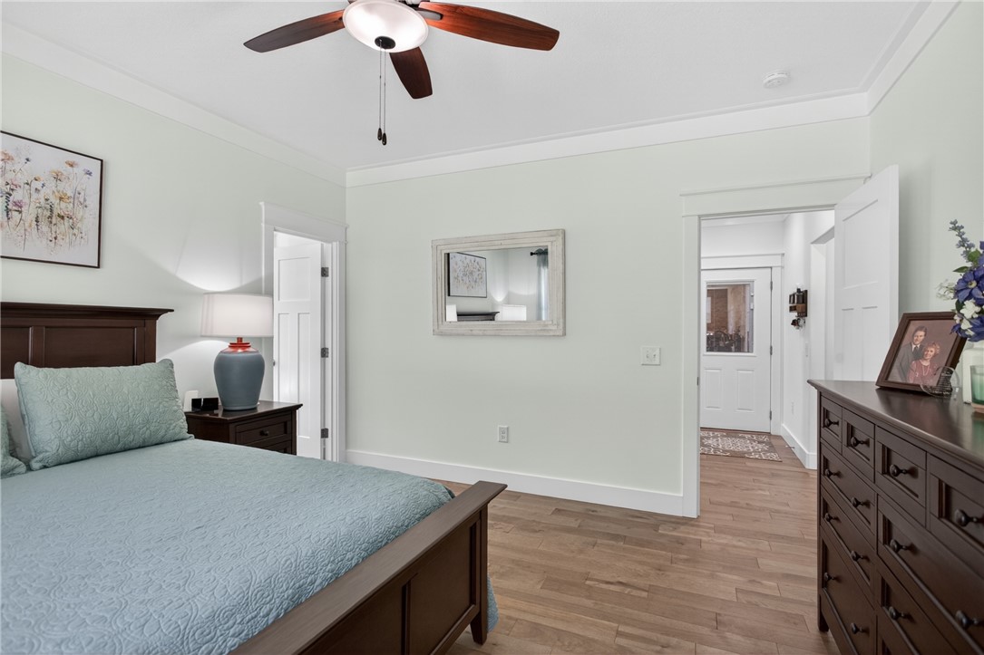921 Falling Waters Lane Seneca, SC 29672 - Photo 23 of 46 Comfortable sleeping space featuring a ceiling fan and elegant wood flooring, creating a serene ambiance.