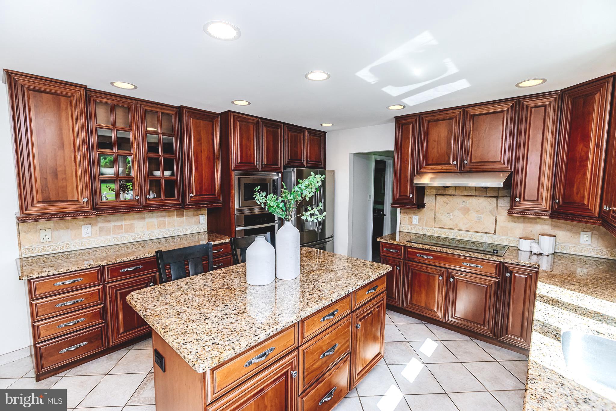 680 Fox Hollow Drive Yardley, PA 19067 - Photo 11 of 63 a kitchen with stainless steel appliances granite countertop a refrigerator a stove and a wooden cabinets