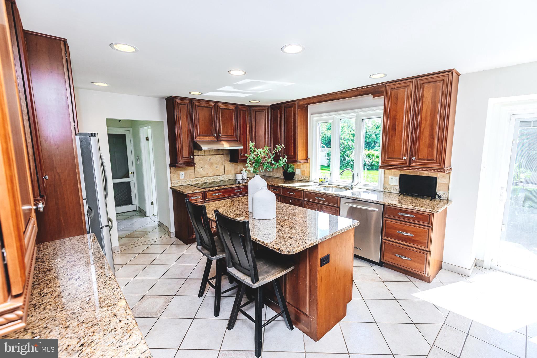 680 Fox Hollow Drive Yardley, PA 19067 - Photo 12 of 63 a kitchen with stainless steel appliances granite countertop a stove a refrigerator and a stove top oven