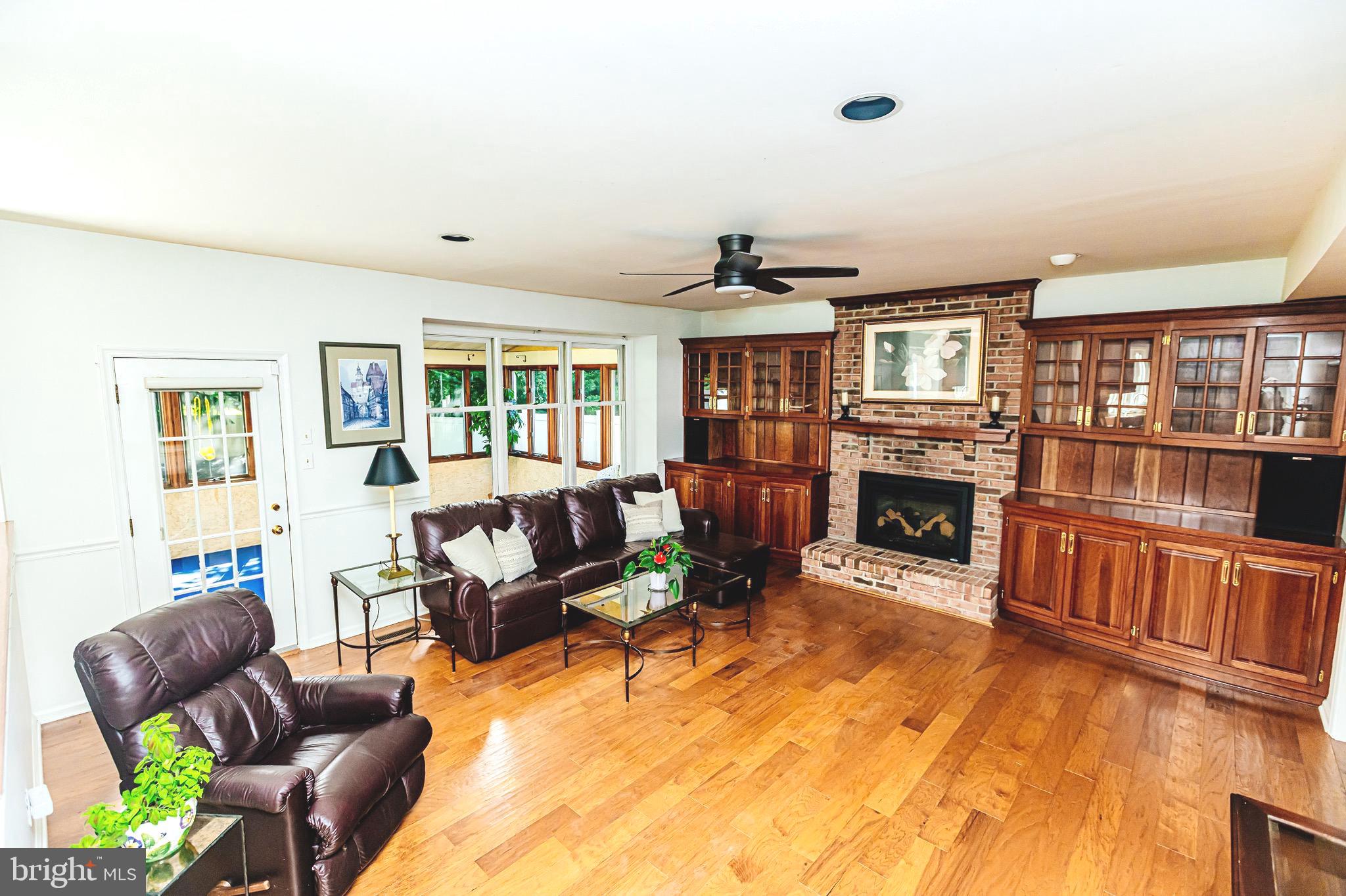 680 Fox Hollow Drive Yardley, PA 19067 - Photo 15 of 63 a living room with furniture a fireplace and a flat screen tv