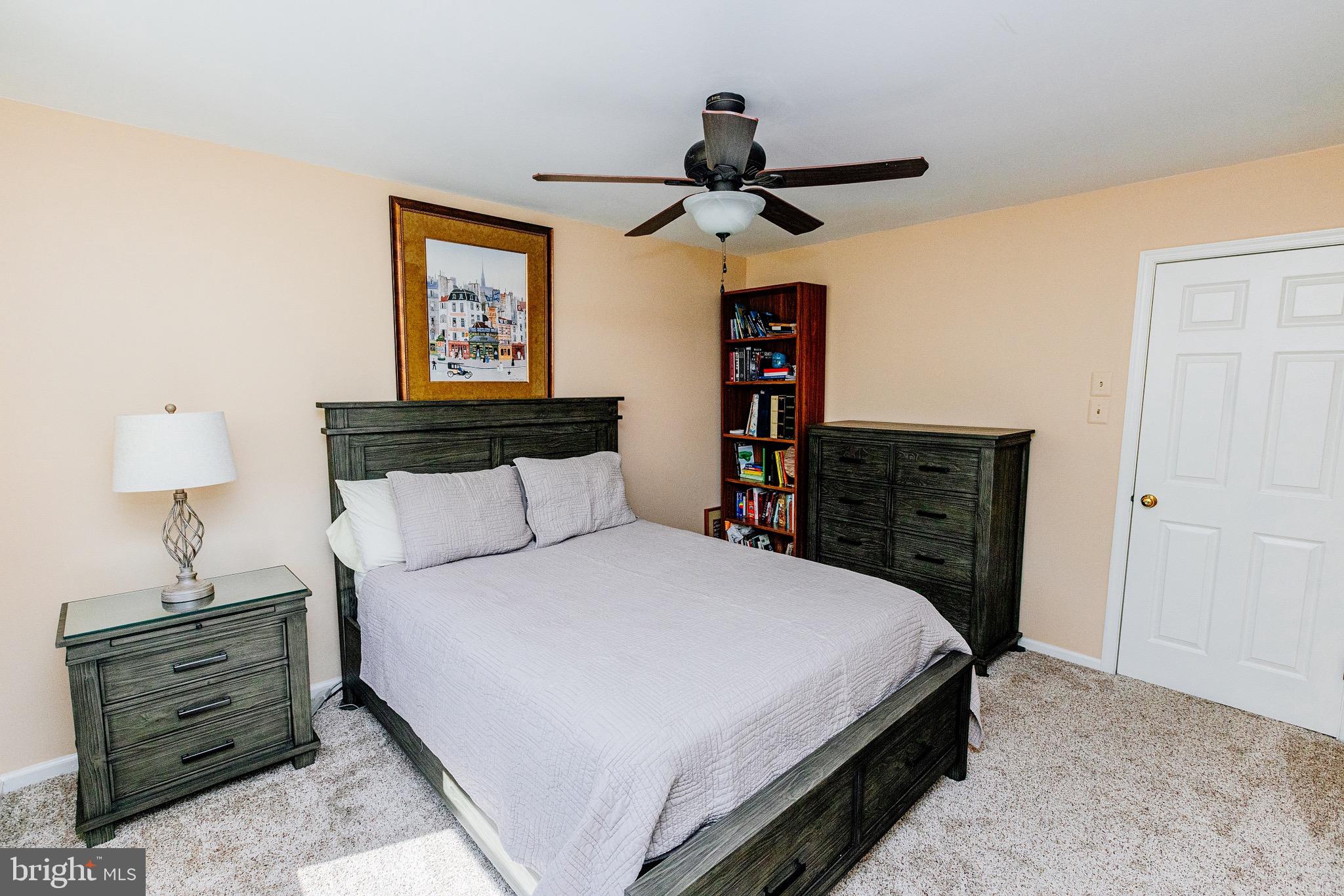 680 Fox Hollow Drive Yardley, PA 19067 - Photo 37 of 63 a bedroom with a bed and a chandelier