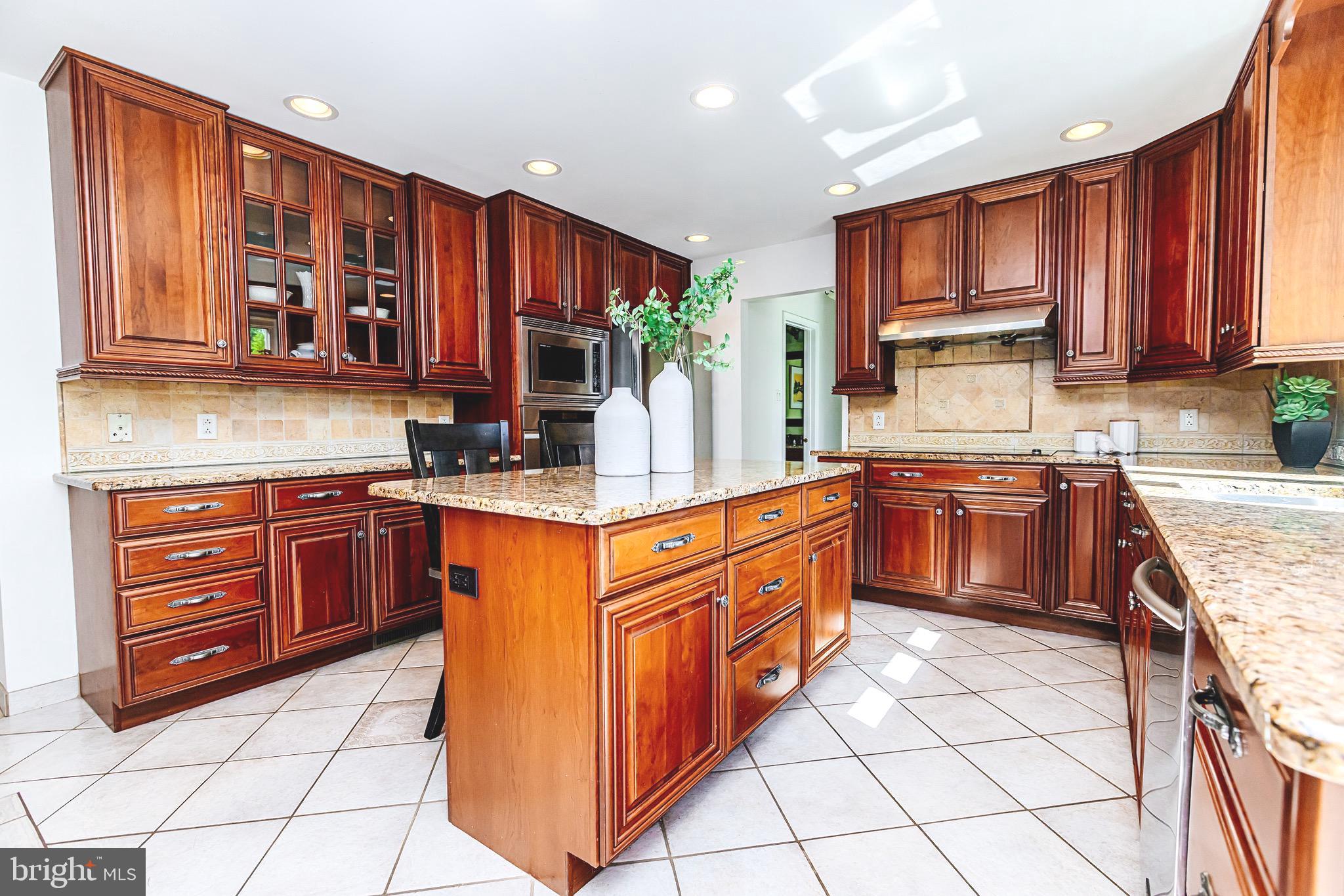 680 Fox Hollow Drive Yardley, PA 19067 - Photo 10 of 63 a kitchen with stainless steel appliances granite countertop wooden cabinets sink and a granite counter top