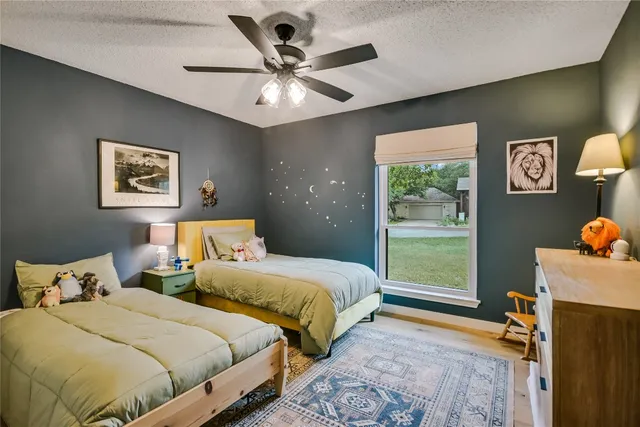 a bedroom with two beds and a window