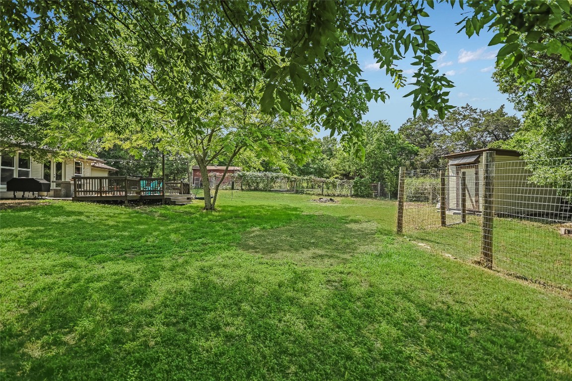 6802 Rio Bravo Lane Austin, TX 78737 - Photo 17 of 18 Fenced backyard featuring a wooden deck