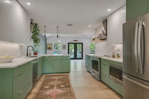 a kitchen with a sink stainless steel appliances and cabinets