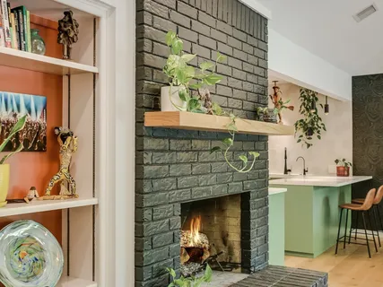a kitchen with a fireplace and a table in it