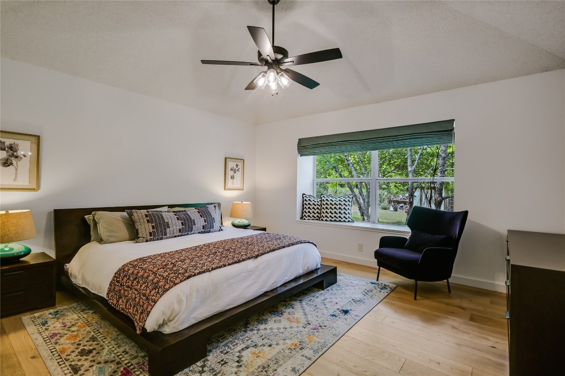 6802 Rio Bravo Lane Austin, TX 78737 - Photo 10 of 18 Bedroom featuring light wood finished floors and ceiling fan