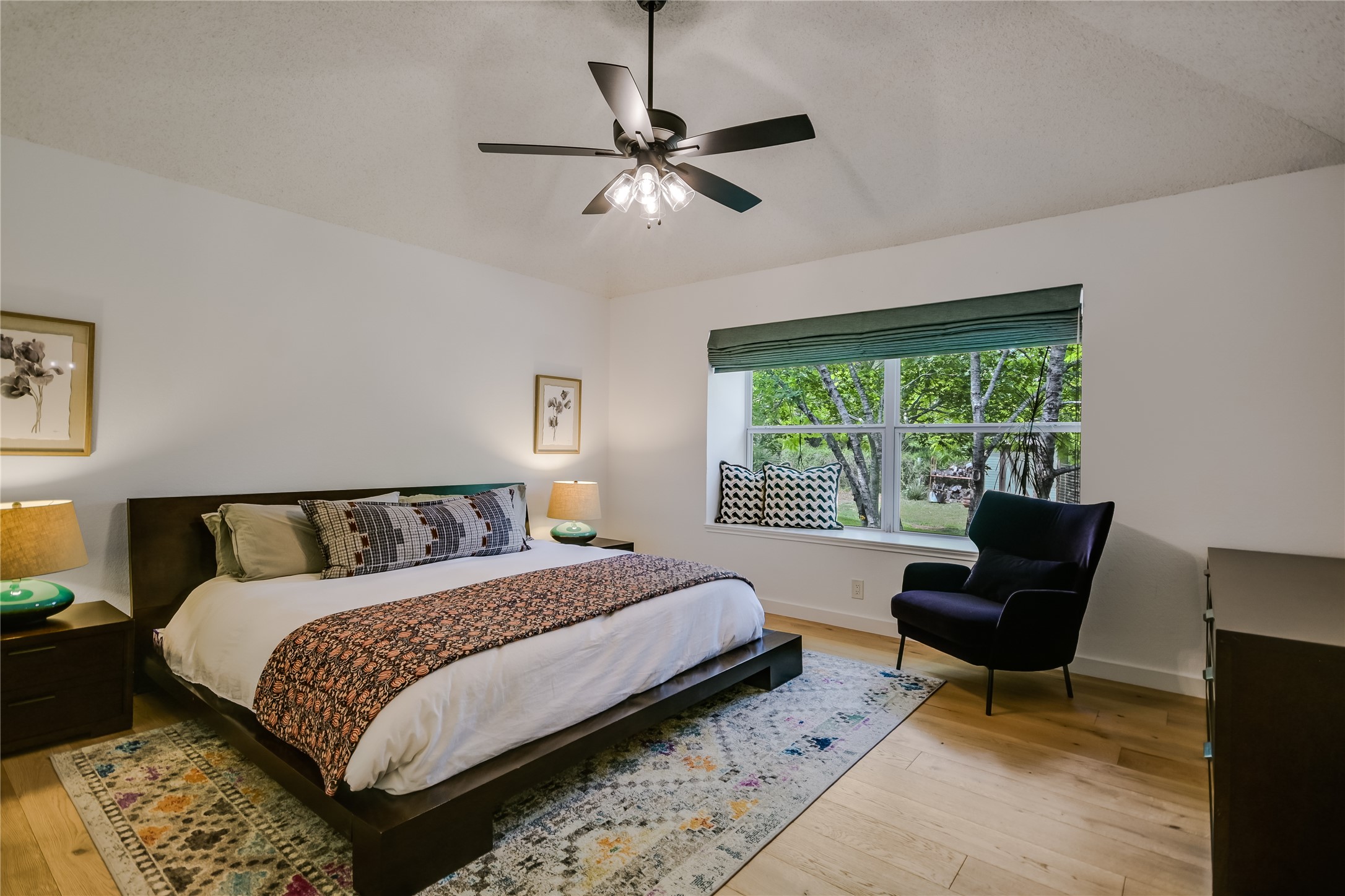 6802 Rio Bravo Lane Austin, TX 78737 - Photo 10 of 18 a bedroom with a bed and a chair