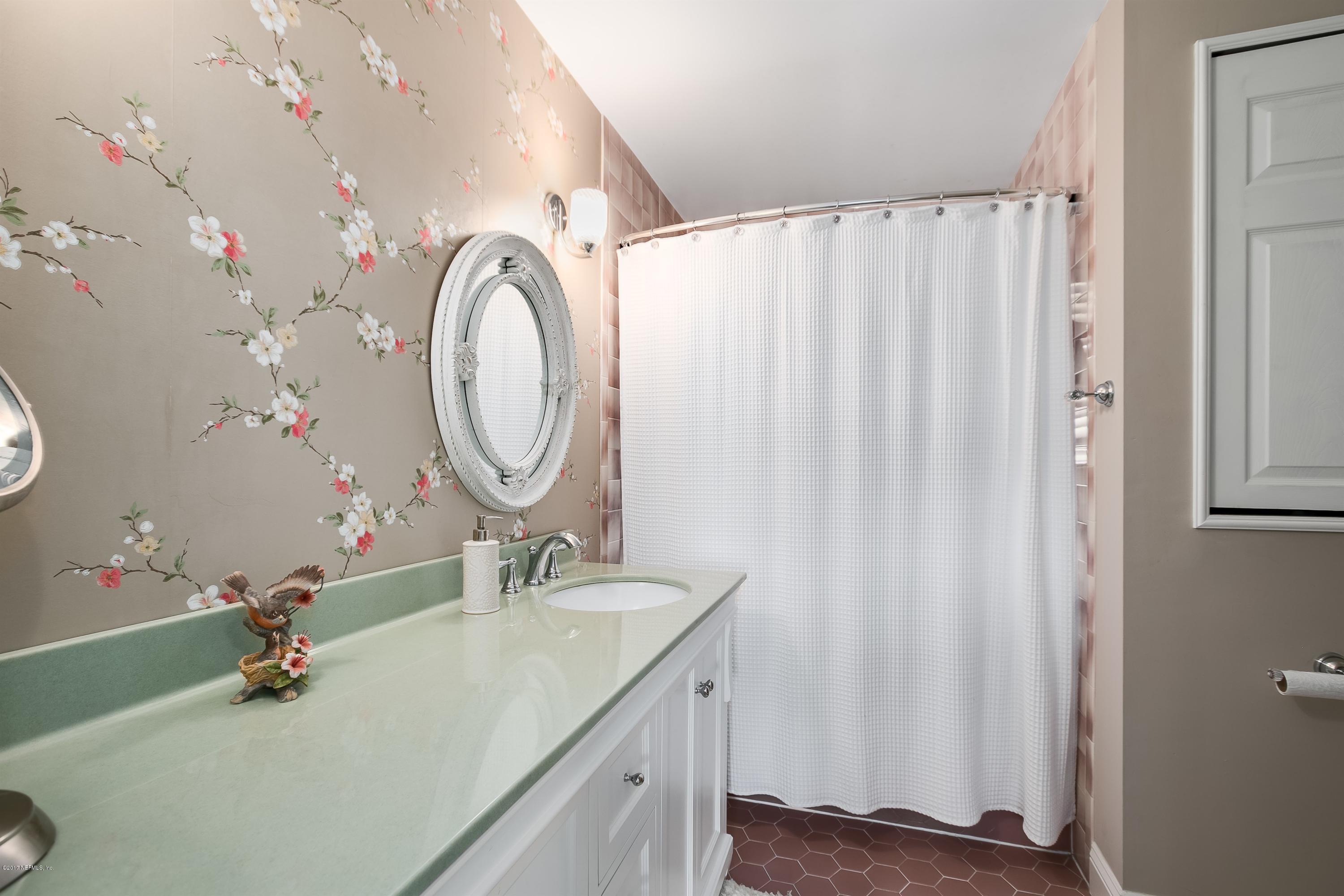 1507 San Rafael Way St. Augustine, FL 32080 - Photo 18 of 32 a bathroom with a double vanity sink and a mirror