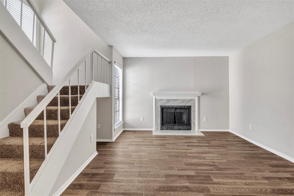 11311 Audelia Road, Unit 271 Dallas, TX 75243 - Photo 1 of 17 Living area with FP and vinyl plank flooring