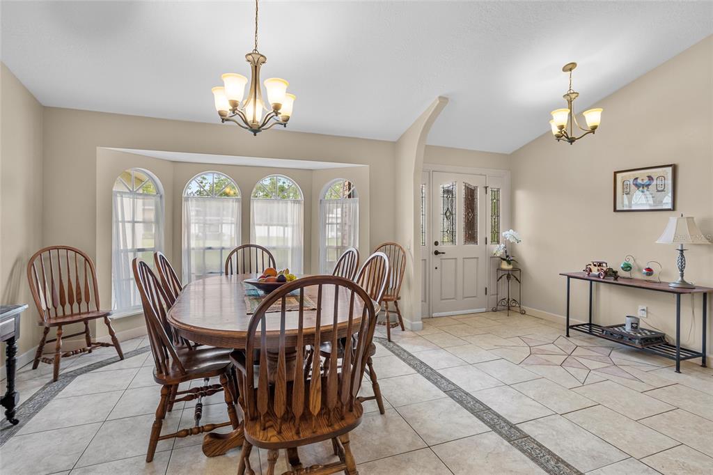 14612 Bray Road Orlando, FL 32832 - Photo 11 of 33 a view of a dining room with furniture and a chandelier
