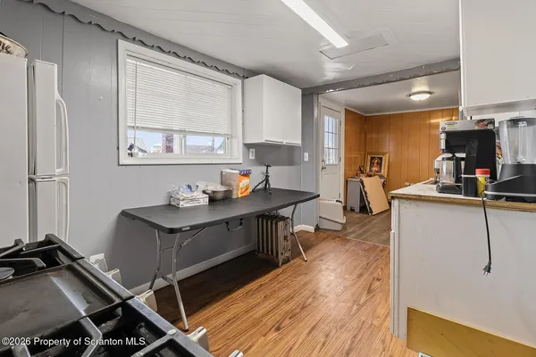 a living room with furniture a wooden floor and a sink
