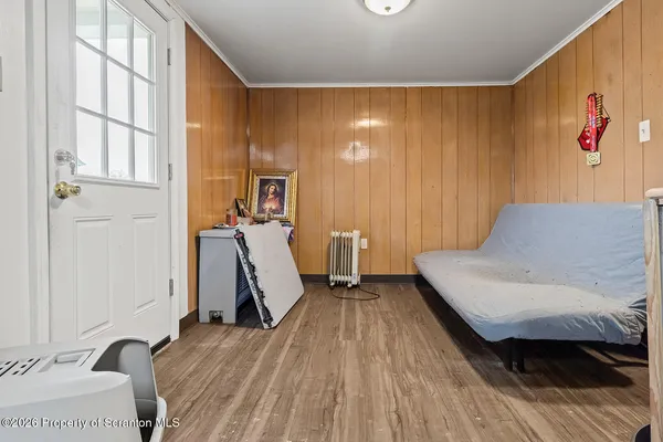 a bedroom with a bed and wooden floor