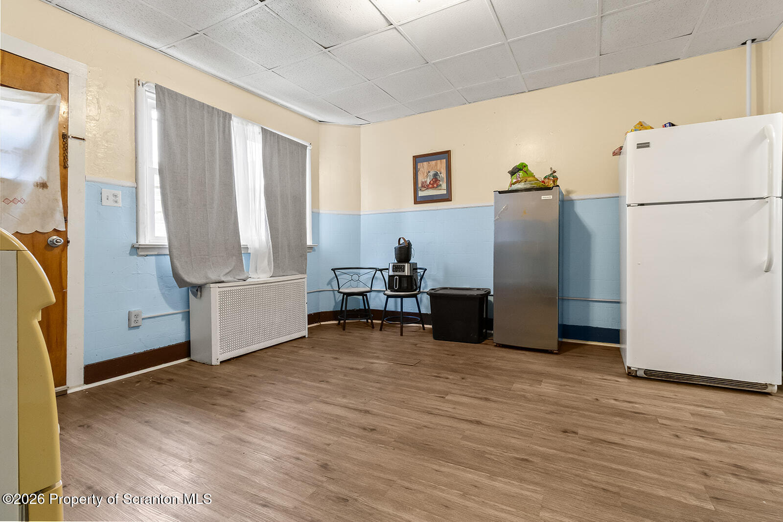 1406 North Main Avenue Scranton, PA 18508 - Photo 9 of 29 a view of a kitchen with refrigerator and wooden floor