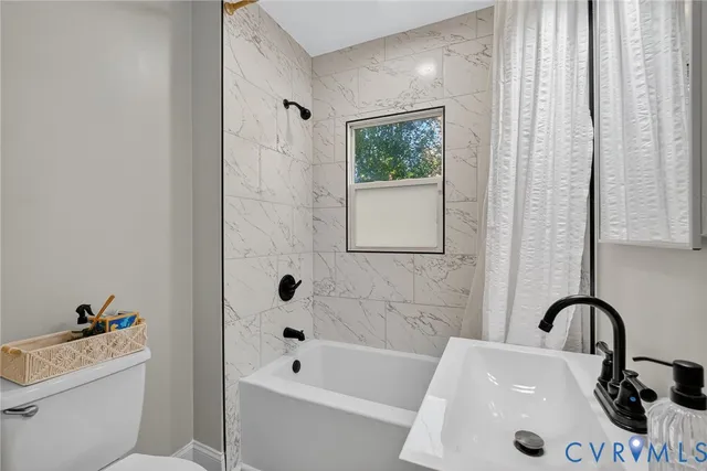 a kitchen with stainless steel appliances granite countertop a stove a washer and dryer