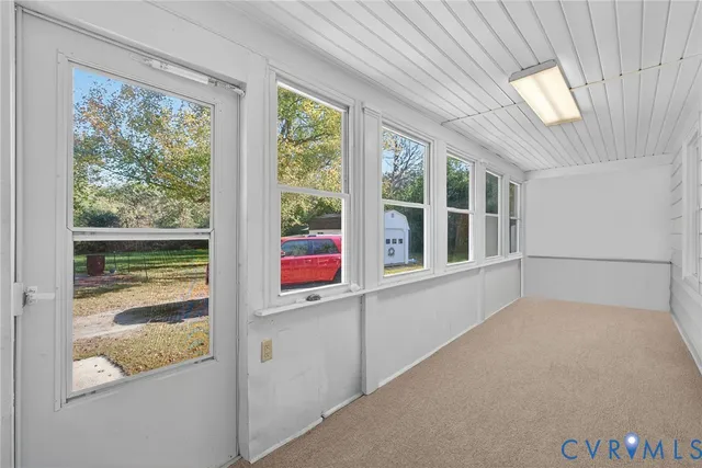 a kitchen with granite countertop a stove top oven and refrigerator