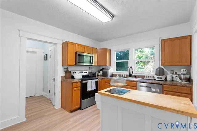 a bathroom with a sink toilet and a window