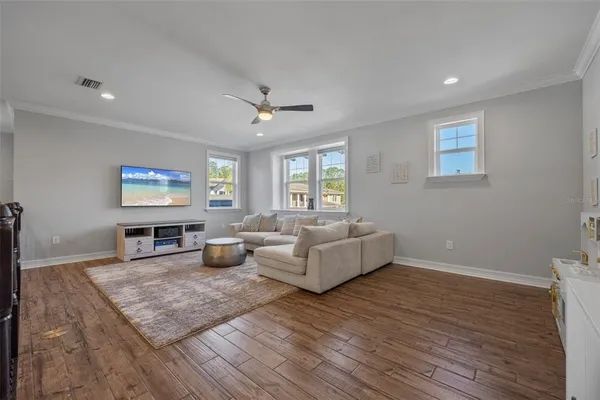 a living room with furniture and wooden floor
