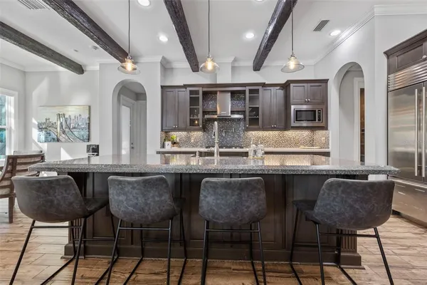 a bathroom with a granite countertop sink mirror vanity and toilet