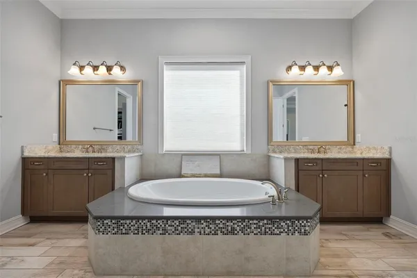 a kitchen with a table chairs microwave and cabinets