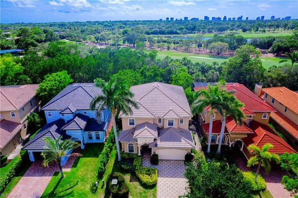 an aerial view of multiple houses with yard
