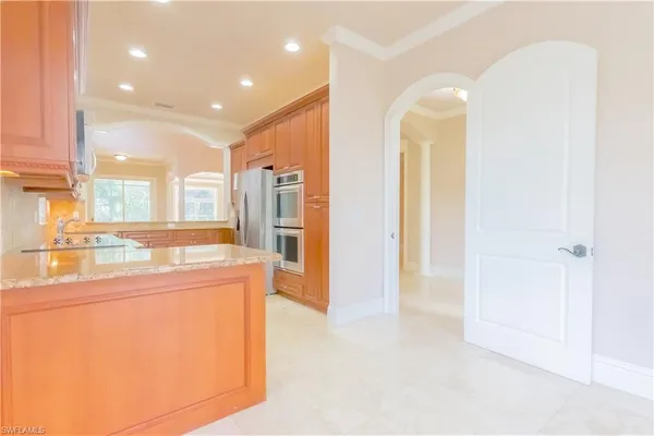 a kitchen with stainless steel appliances granite countertop a refrigerator and a sink