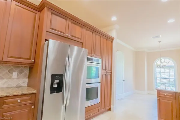a view of a kitchen with an entryway and wooden floor