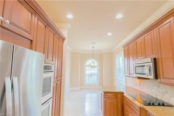 a kitchen with stainless steel appliances granite countertop a stove a microwave and a sink
