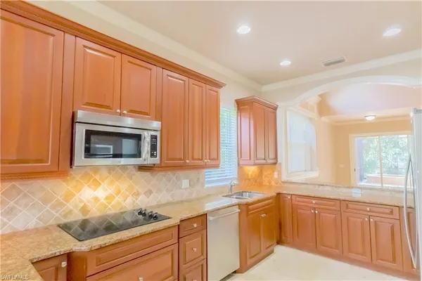 a view of kitchen with refrigerator and window