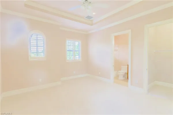 an empty room with a ceiling fan and a window