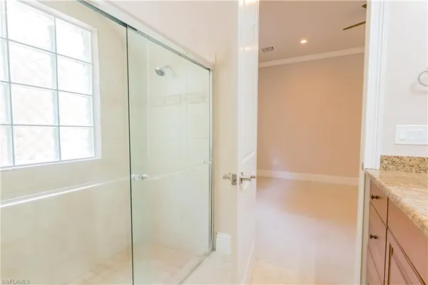 a bathroom with a shower and a glass door