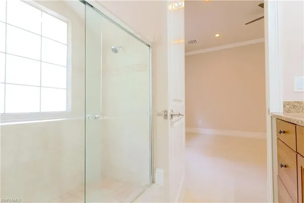 a bathroom with a granite countertop sink a shower and a mirror