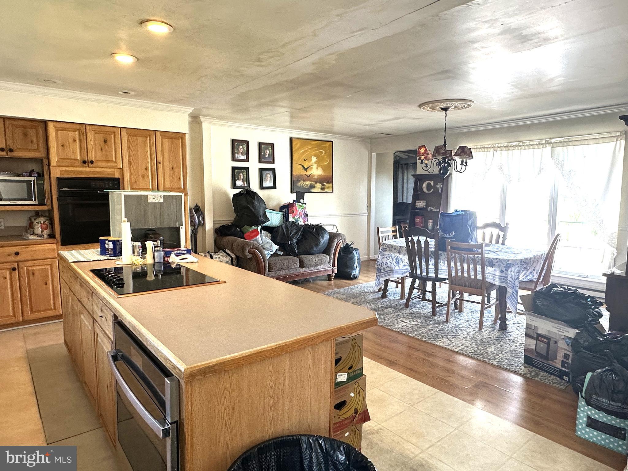 21125 Bay Berry Road Tylerton, MD 21866 - Photo 2 of 20 a kitchen that has a table chairs and a refrigerator