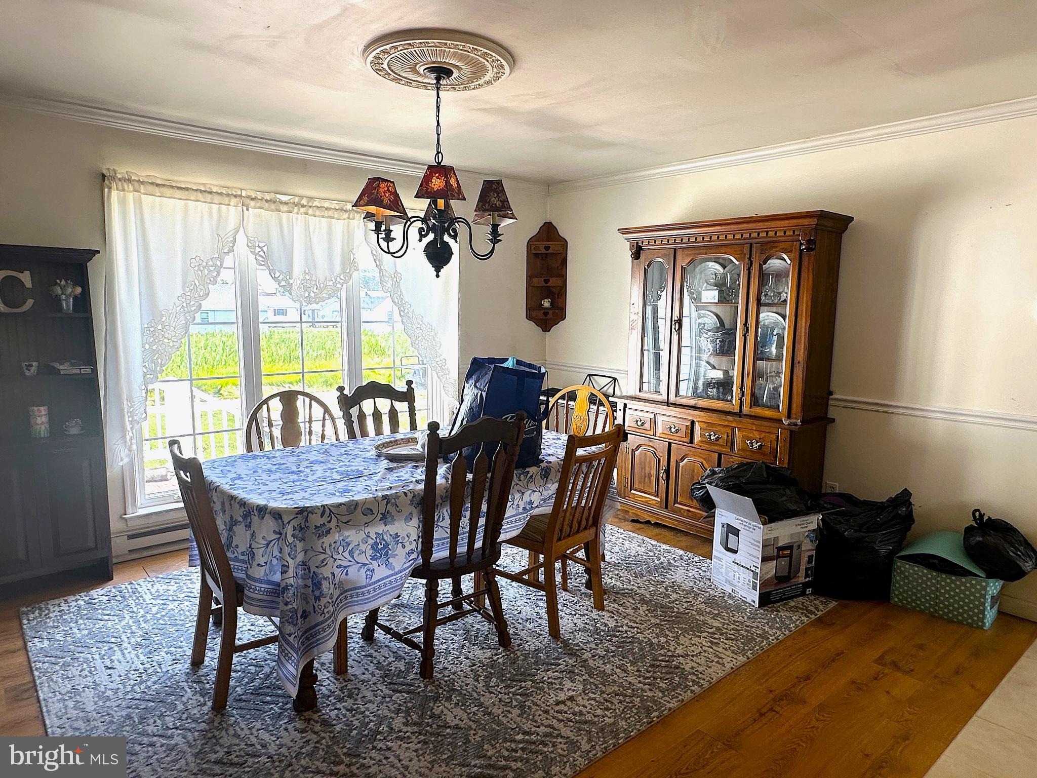 21125 Bay Berry Road Tylerton, MD 21866 - Photo 4 of 20 a dining room with furniture a chandelier and a rug