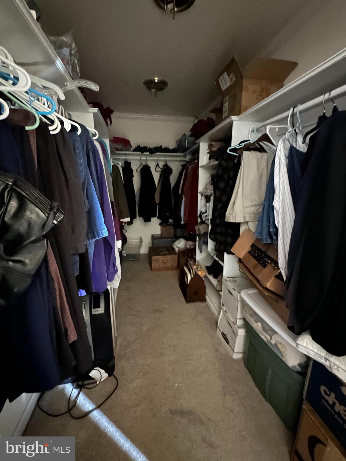 21125 Bay Berry Road Tylerton, MD 21866 - Photo 8 of 20 a view of walk in closet with clothes and shoes