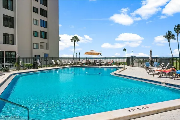 a view of a swimming pool with an outdoor seating