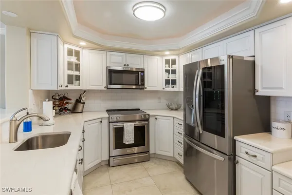 a kitchen with a sink and wooden floor