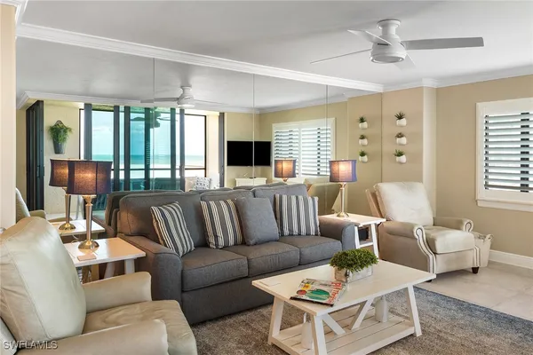 a living room with furniture a rug and white walls