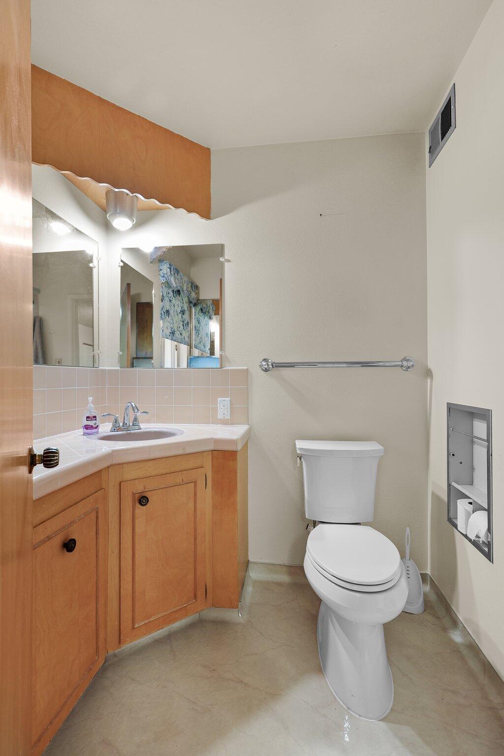 910 Hallmark Drive Redding, CA 96001 - Photo 20 of 40 a bathroom with a toilet sink and mirror