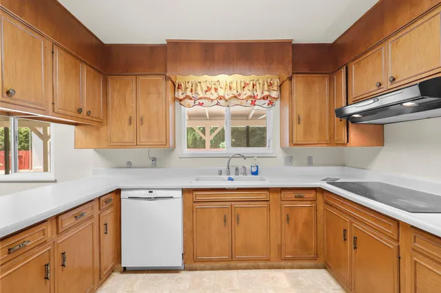 a kitchen with a sink stove and cabinets