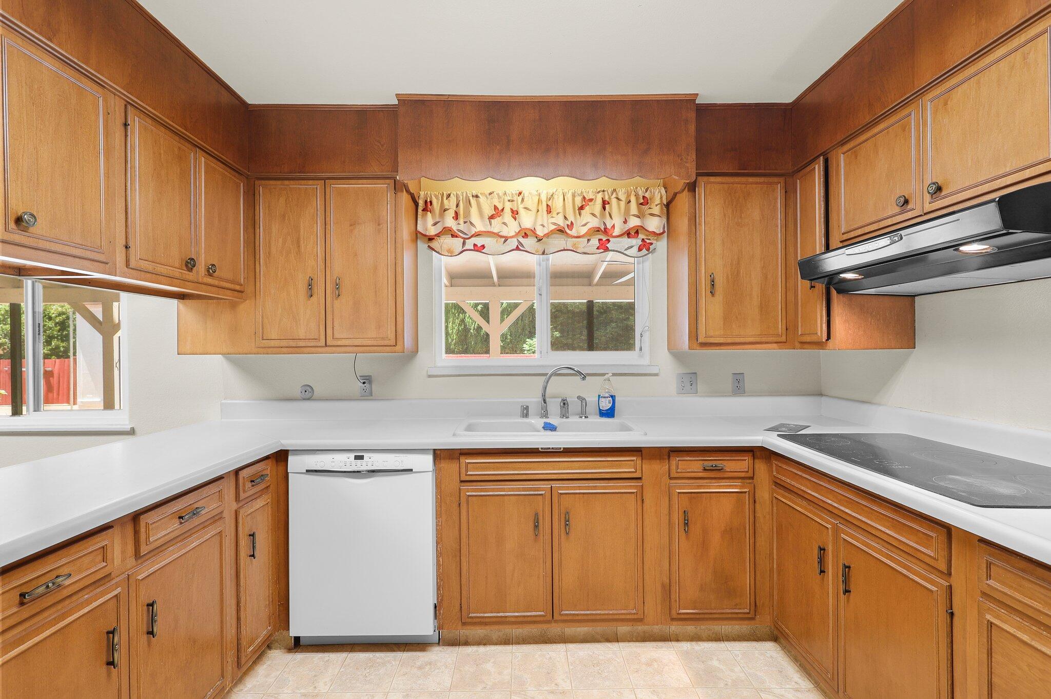 910 Hallmark Drive Redding, CA 96001 - Photo 7 of 40 a kitchen with a sink stove and cabinets