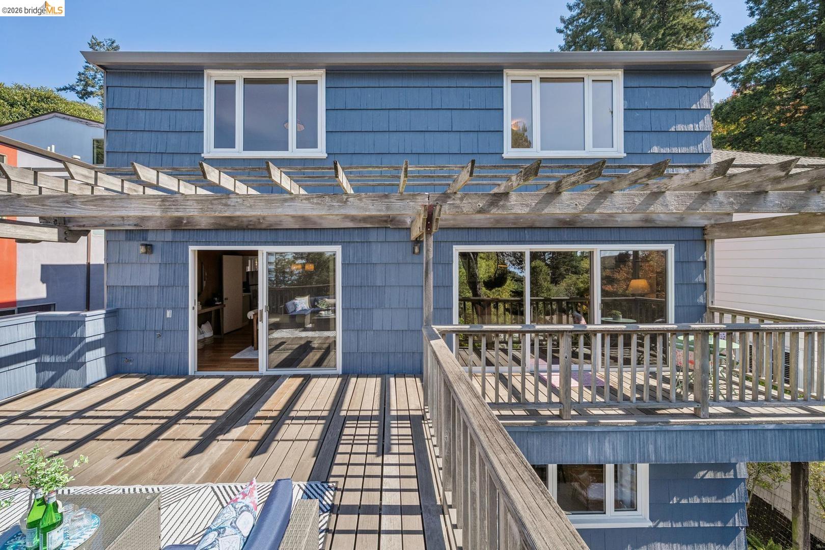 155 Avenida Drive Berkeley, CA 94708 - Photo 20 of 86 Multi-level decking with wood railing, pergola, and blue shingle siding