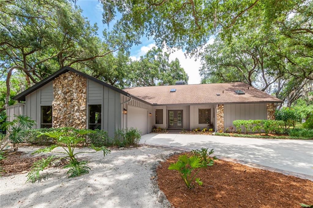 4833 Stone Ridge Trail Sarasota, FL 34232 - Photo 1 of 1 a front view of a house with garden