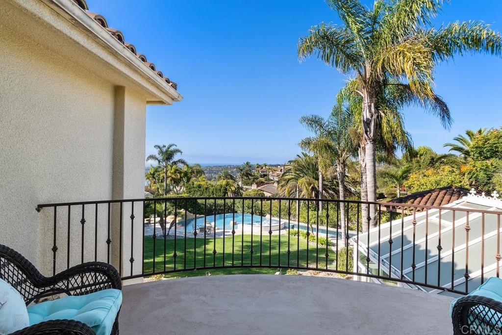 1620 Bella Vista Drive Encinitas, CA 92024 - Photo 17 of 35 a view of a house with a floor to ceiling window and a palm tree