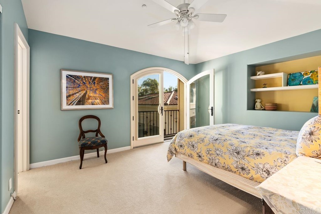 1620 Bella Vista Drive Encinitas, CA 92024 - Photo 23 of 35 a bedroom with a bed and a chandelier