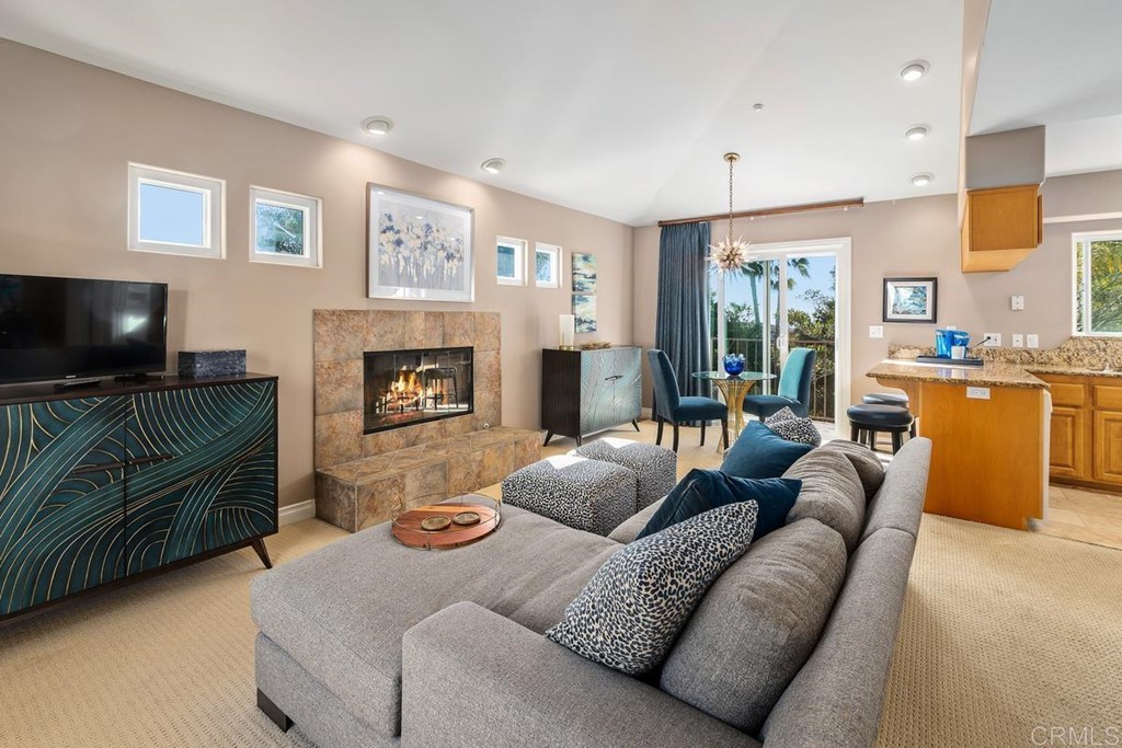 1620 Bella Vista Drive Encinitas, CA 92024 - Photo 25 of 35 a living room with furniture flat screen tv and a fireplace